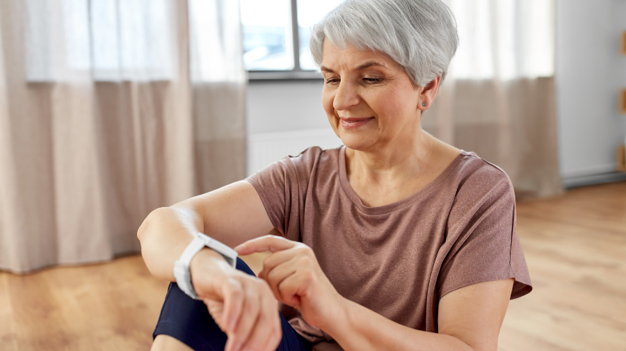 Older woman tracking health data with wearable device